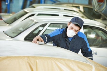 repairman sanding automobile roofの写真素材