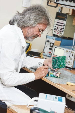 technician engineer at work with microchipの写真素材