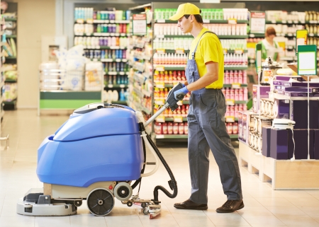 Floor care and cleaning services with washing machine in supermarket shop storeの写真素材