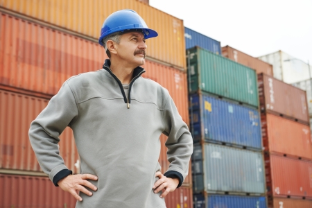 adult terminal cargo dock warehouse worker in front of maritime shipping container