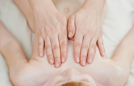 Masseur making a massage to child leg foot and bodyの写真素材