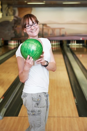 Cheerful young adult woman bowling playerの写真素材