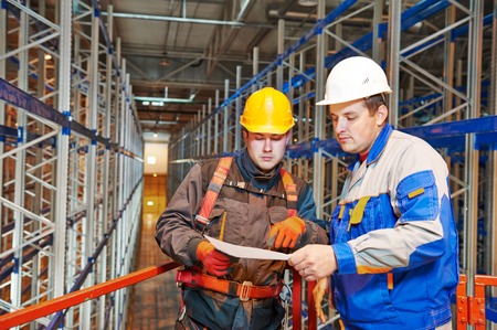 two warehouse worker in front of rack stack in storehouse