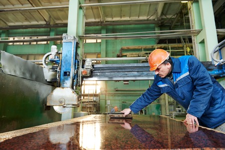 industrial worker at factory on granite or marble manufacturÑƒ