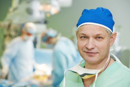 Male surgeon in uniform in front of cardiac surgery operation room at clinicの写真素材