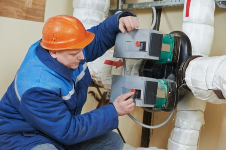 repairman engineer of fire engineering system or heating system open the valve equipment in a boiler...