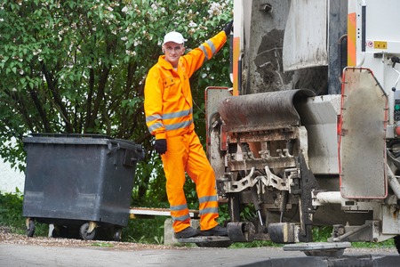 Worker of recycling garbage collector truck loading waste and trash binの写真素材
