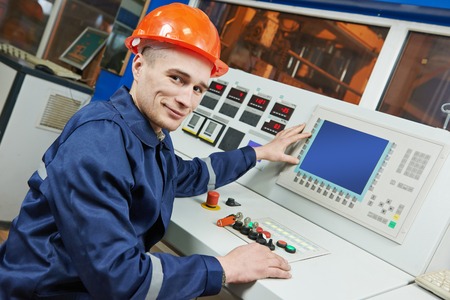 industrial engineer worker operating control panel system at modern manufacture plant