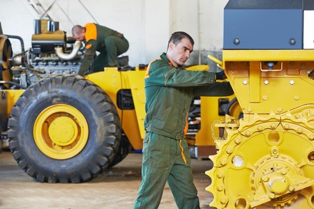 industrial worker during heavy industry machinery assembling on production line manufacturing workshop at factoryの写真素材