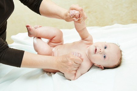 Masseur making a massage to child bodyの写真素材