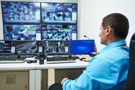 security guard watching video monitoring surveillance security system