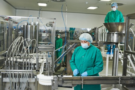 pharmaceutical factory woman worker operating production line at pharmacy industry manufacture...