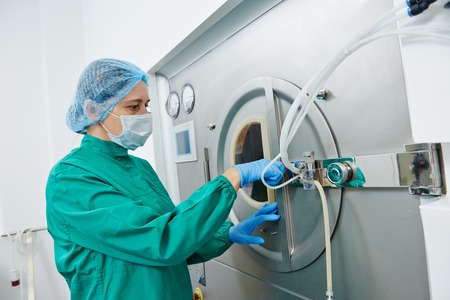 pharmaceutical factory woman worker operating tablet glazing production line at pharmacy industry...