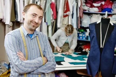 young male tailor portrait in workshop