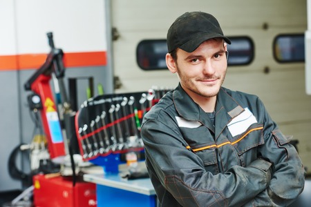 repairman auto mechanic portrait in car auto repair or maintenance shop service stationの写真素材