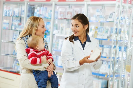 Automobile glazier repairman teaching or discussing with partner windscreen repair of a car in auto service station garageの写真素材