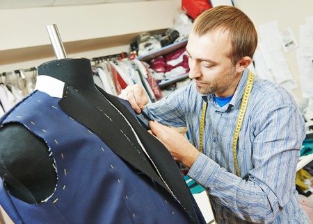 young male tailor portrait in workshop