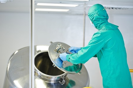 pharmaceutical factory man worker operating mixing machine at pharmacy production industry...