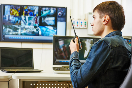 security guard watching video monitoring surveillance security system
