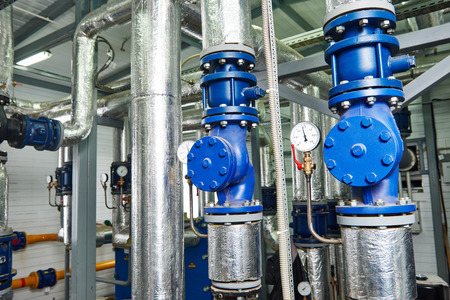Closeup of manometer, pipes and faucet valves of gas heating system in a boiler room