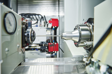 shaft detail turning on metal cutting machine tool at manufacturing factory