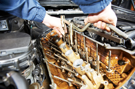 mechanic repairman at automobile car engine maintenance repair workの写真素材
