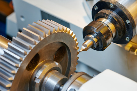 metal working. Process of tooth gear wheel finish machining by cutter tool at factory