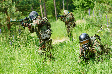 military. two soldier with assault rifle in uniform patrolling territory outdoorsの写真素材