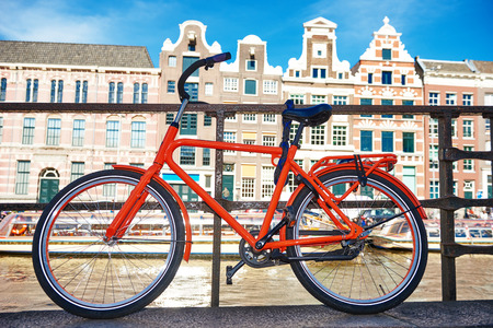 bicycle on the city street river channel bridge in Amsterdamの写真素材