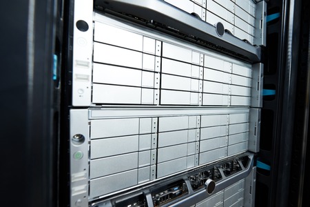 Row of hard drives mounted in a rack in a data center