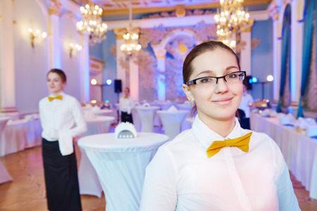 waitress occupation. Young woman with food on dishes servicing in restaurant during catering the...