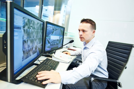 security guard officer watching video monitoring surveillance security systemの写真素材
