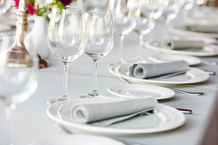 catering services. glasses for wine and dishes plates with cutlery in restaurant before eventの写真素材