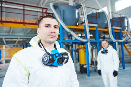 two chemical industry workers at industrial factory