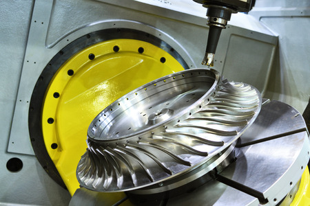 Milling cutting metalworking process. Precision industrial CNC machining of turbine metal detail by mill at factoryの写真素材