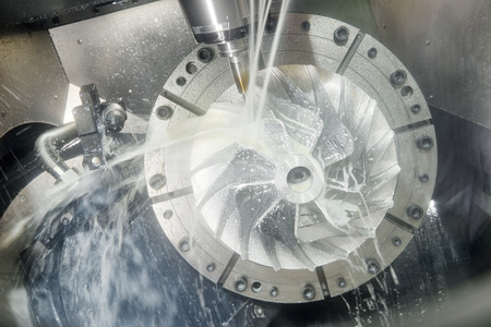 Milling metalworking process. Industrial CNC machining of metal detail by cutting end-tooth vertical mill at factoryの写真素材