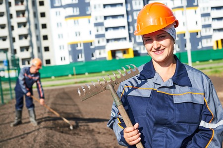 Portrait of happy municipal construction landscaper worker making urban improvement, landscaping and...