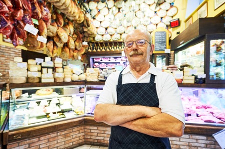 adult male seller portrait in butcher storeの写真素材