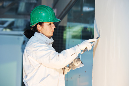 Plasterer at indoor wall work