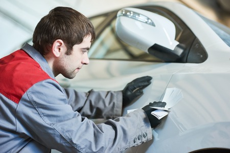 colourist man selecting color of car with paint matching samplesの写真素材