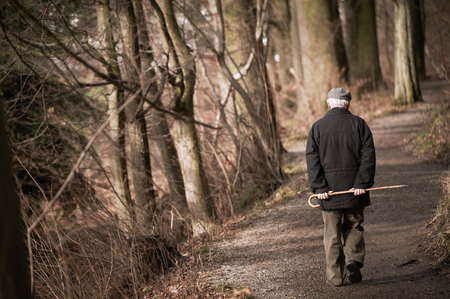 Elderly man going away in park. Tonedの写真素材