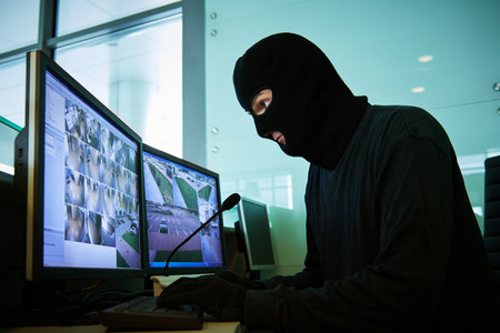 robber near surveillance video monitoring system coordinating robberyの写真素材