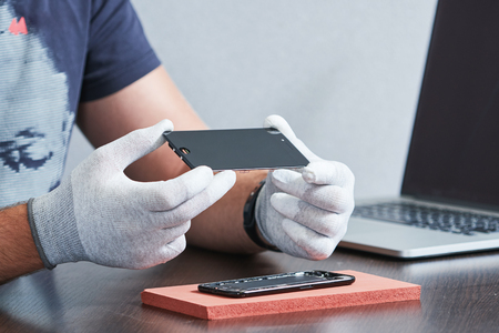 smart phone repair. repairman hands with screenの写真素材