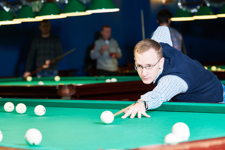 man playing billiards in club