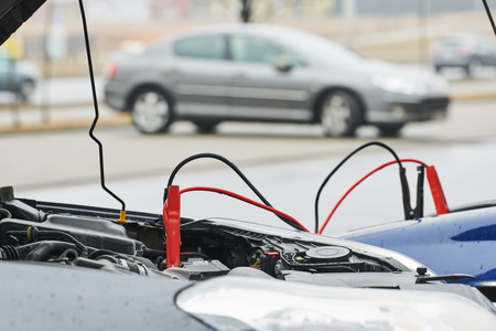 Automobile help. booster jumper cables charging automobile discharged battery