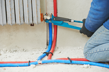 engineer repairmen installing heating system