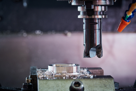 Milling metalworking process. Industrial CNC metal machining by vertical mill. Coolant and lubricationの写真素材