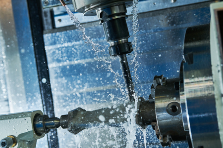 Milling metalworking process. Industrial CNC metal machining by vertical mill. Coolant and lubricationの写真素材