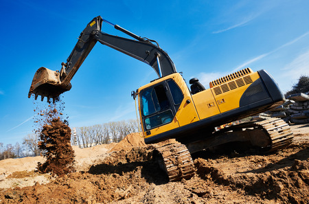 excavator loader machine at construction siteの写真素材