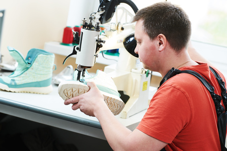 Shoemaker repair shoe. sewing the sole of footwearの写真素材
